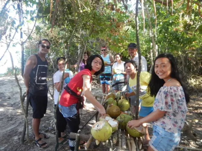 Enjoying fresh coconut in Penitan Bay