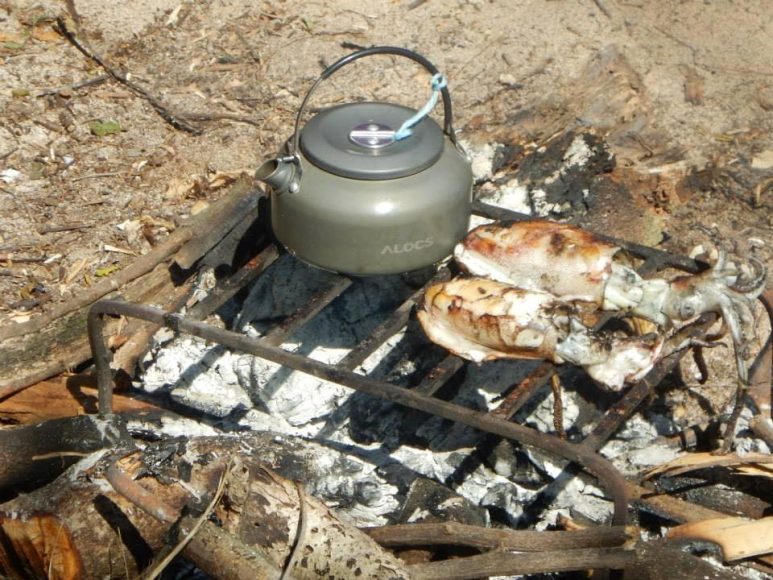 Grilling squids in Penitan Bay