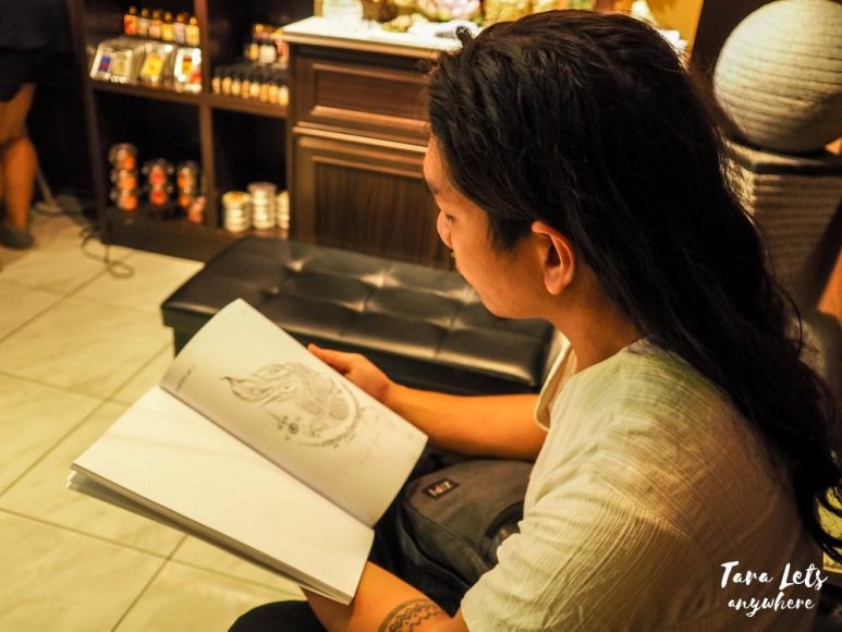 Hali with a book of Sak Yant designs